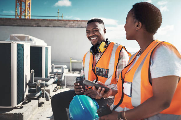 Shot of a young man and woman having a coffee break at a construction site